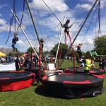 kids enjoying the 4-in-1 bungee trampoline in a fair