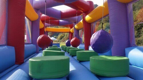 colourful inflatable ball run challenge with platforms to jump onto