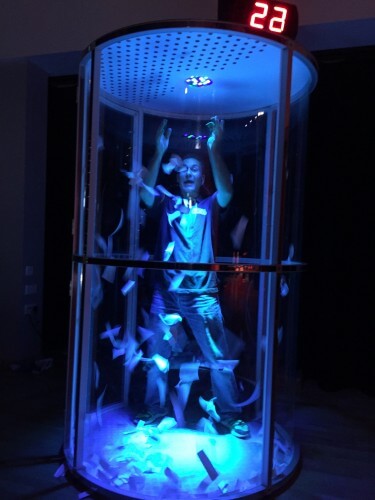 a man inside the LED lit cash grabber cube